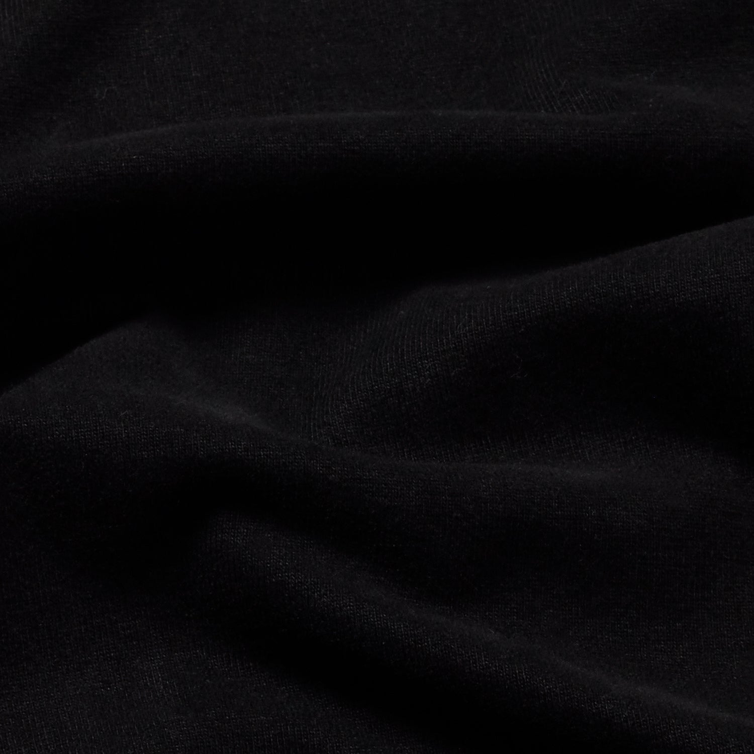 Close-up of the black Berlin Tee's fabric texture.