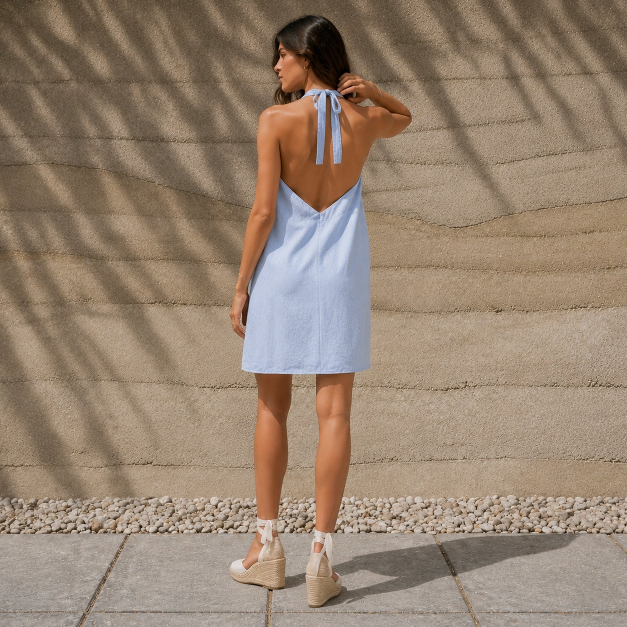 Linen Halter Dress in Light Blue, lifestyle view 2, showing neckline and dress silhouette